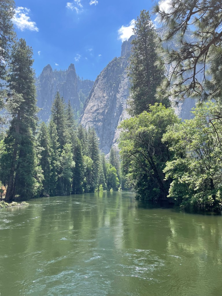 River running through trees towards mountains. Yosemite National Park, California